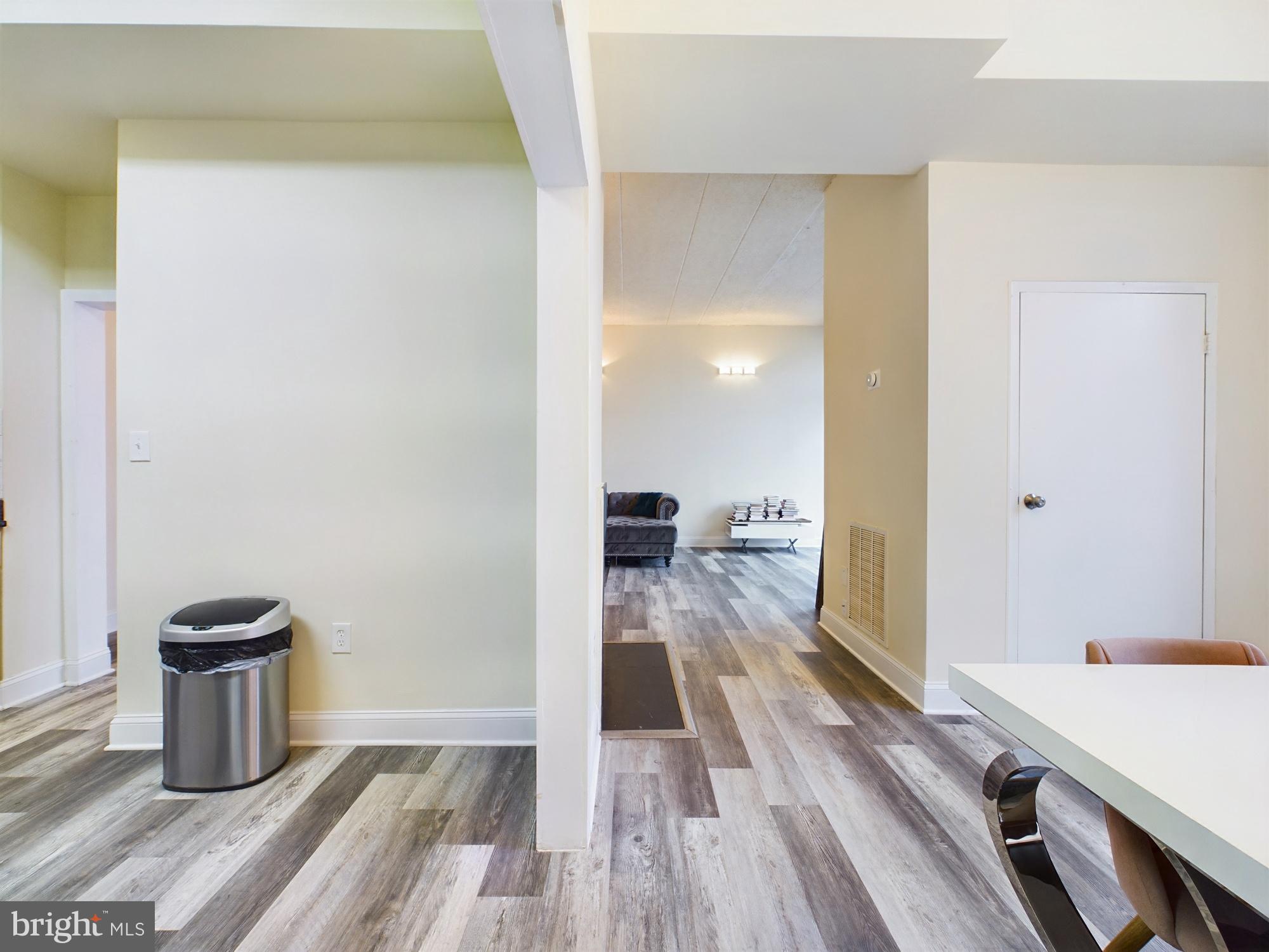 11566 Rolling Green Court, Unit 101 Reston, VA 20191 - Photo 13 of 38 a view of a room with wooden floor and furniture
