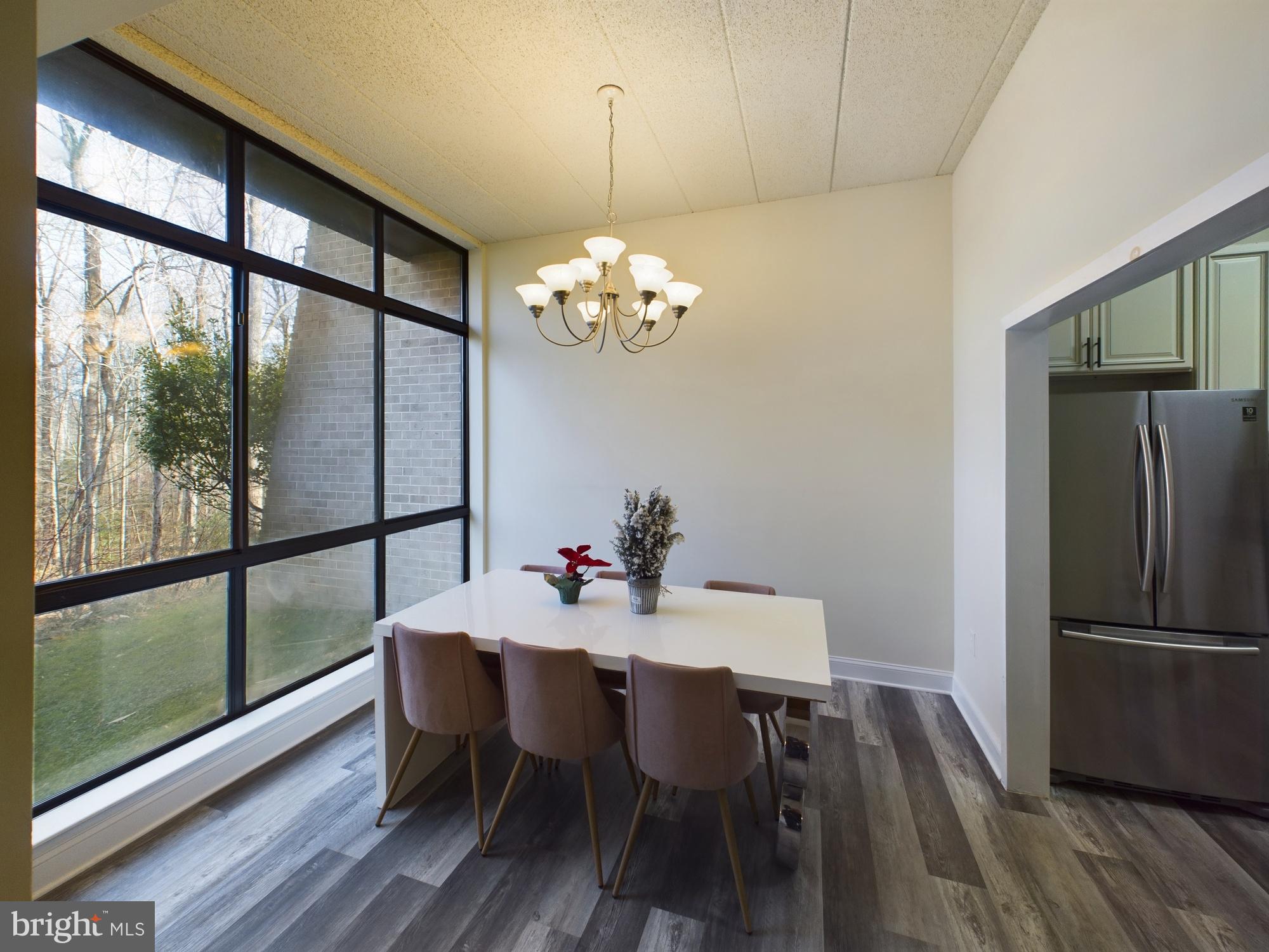 11566 Rolling Green Court, Unit 101 Reston, VA 20191 - Photo 14 of 38 a view of a dining room with furniture window and wooden floor