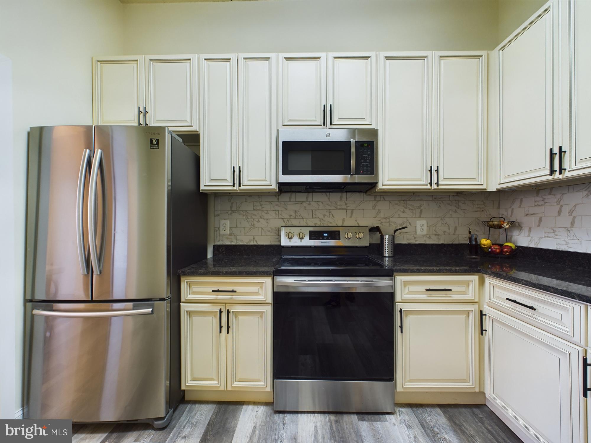 11566 Rolling Green Court, Unit 101 Reston, VA 20191 - Photo 19 of 38 a kitchen with cabinets stainless steel appliances and a window