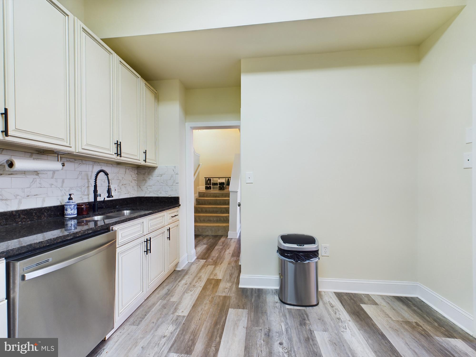11566 Rolling Green Court, Unit 101 Reston, VA 20191 - Photo 20 of 38 a kitchen with a sink and a stove top oven