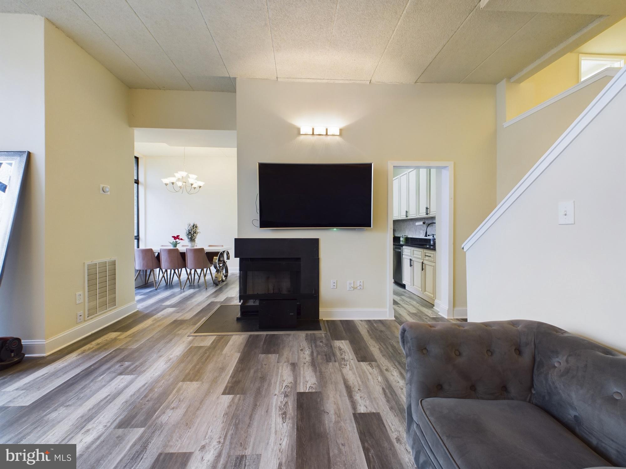11566 Rolling Green Court, Unit 101 Reston, VA 20191 - Photo 22 of 38 a living room with furniture and a flat screen tv