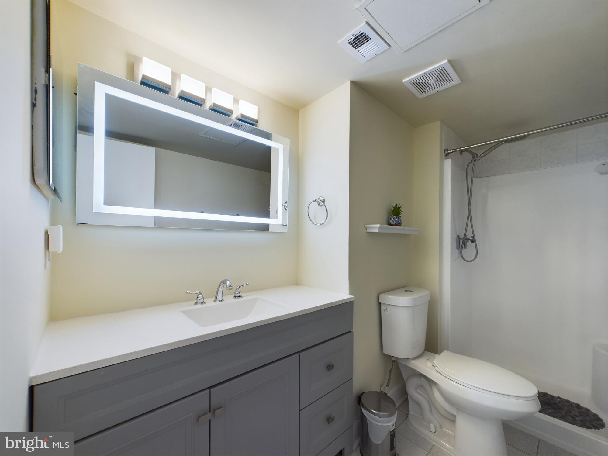 11566 Rolling Green Court, Unit 101 Reston, VA 20191 - Photo 28 of 38 a bathroom with a toilet sink and mirror