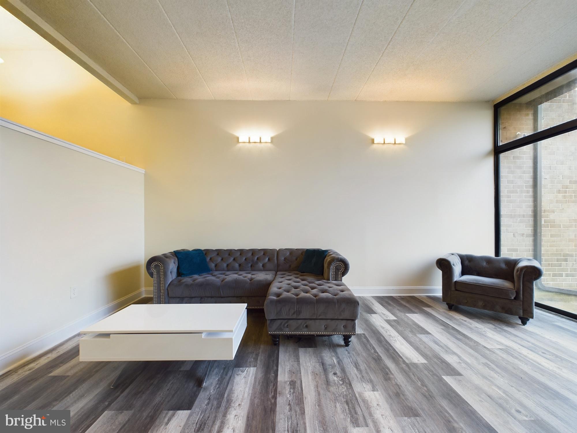 11566 Rolling Green Court, Unit 101 Reston, VA 20191 - Photo 3 of 38 a living room with furniture and a couch