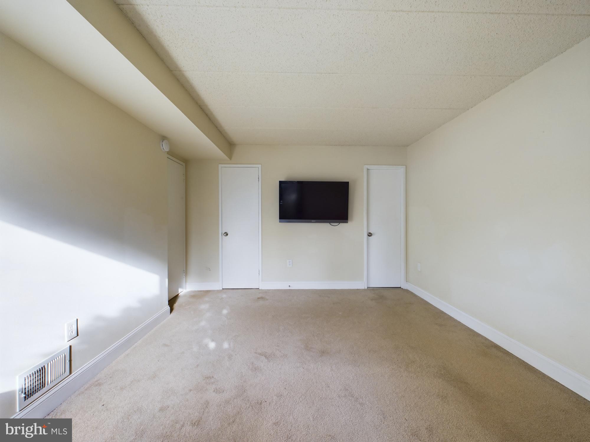 11566 Rolling Green Court, Unit 101 Reston, VA 20191 - Photo 34 of 38 a view of a livingroom with an empty space and a window