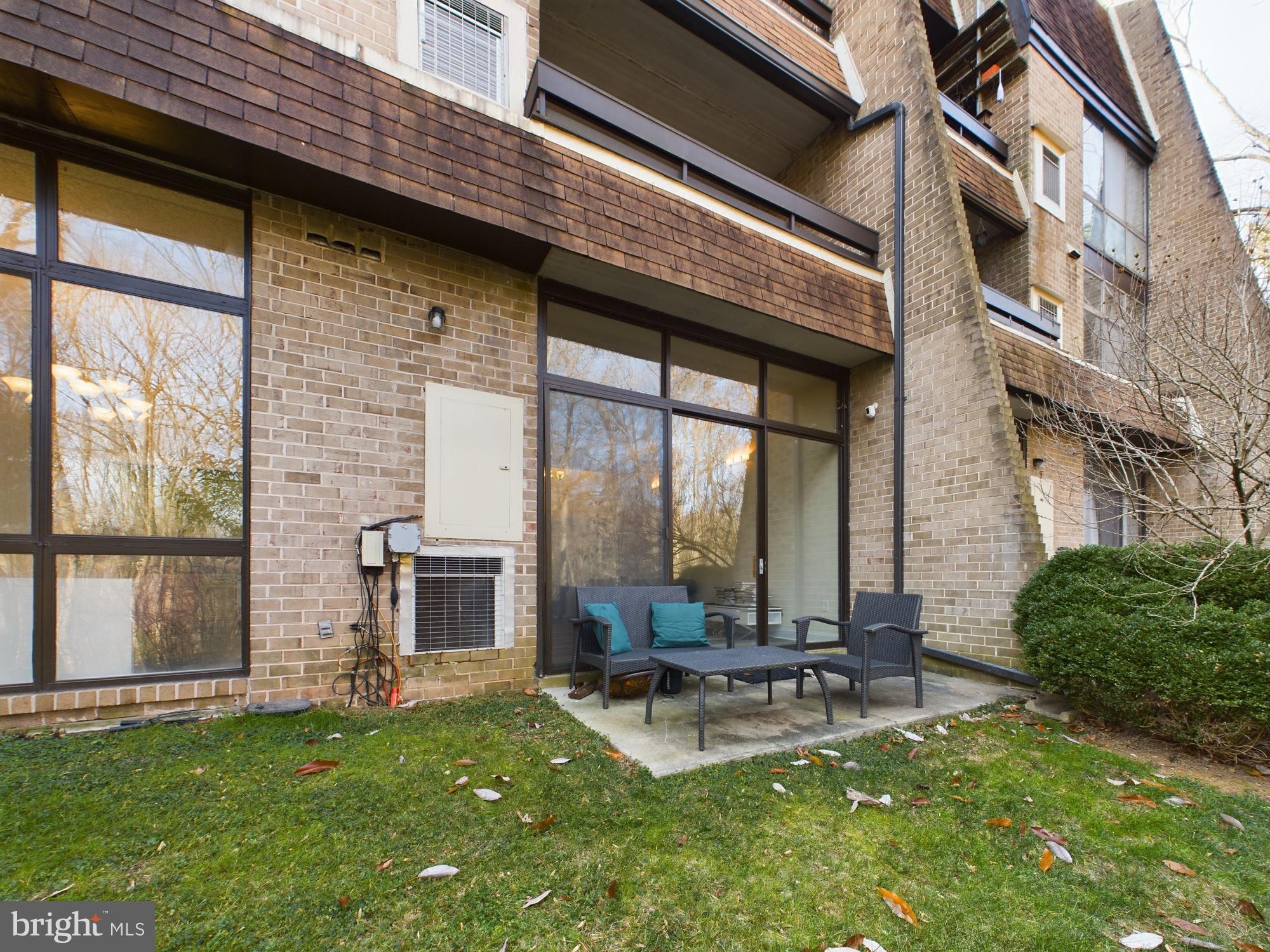 11566 Rolling Green Court, Unit 101 Reston, VA 20191 - Photo 10 of 38 a view of a patio with couches chairs and swimming pool