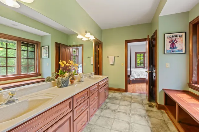 a spacious bathroom with sink and mirror