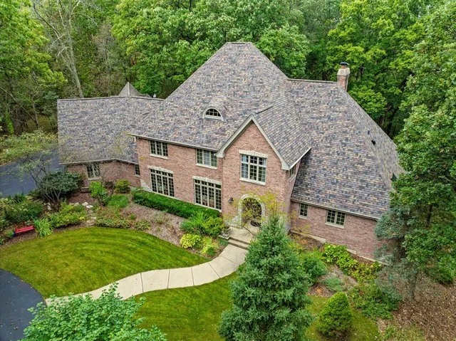 an aerial view of a house with a yard