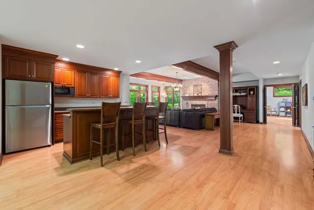a view of a kitchen with furniture and a refrigerator