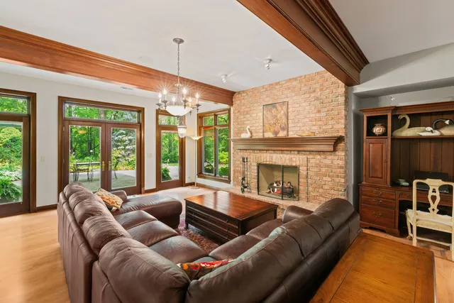 a living room with furniture fireplace and a large window