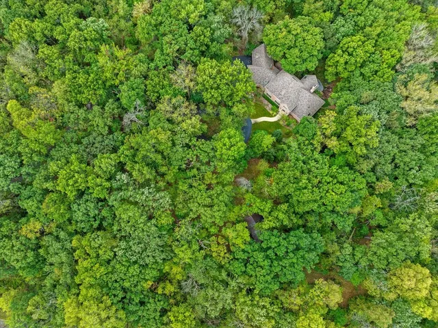 an aerial view of a house with a yard