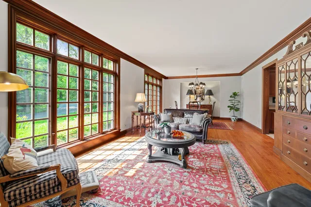 a living room with furniture and a floor to ceiling window