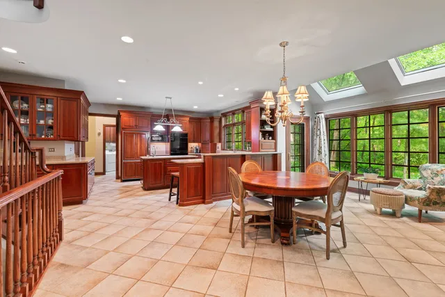a dining room with furniture a chandelier and window