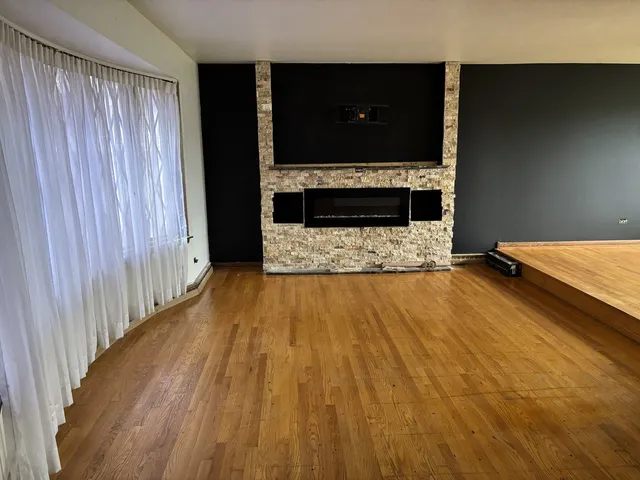 a view of kitchen and hall with wooden floor