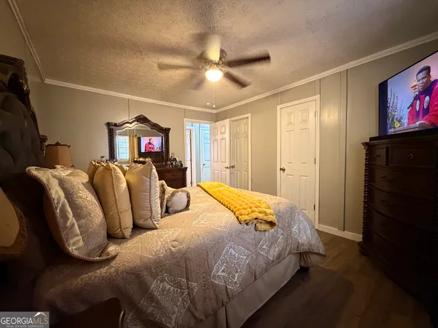 a bedroom with bed and tv