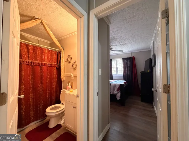 a bathroom with a toilet and a shower