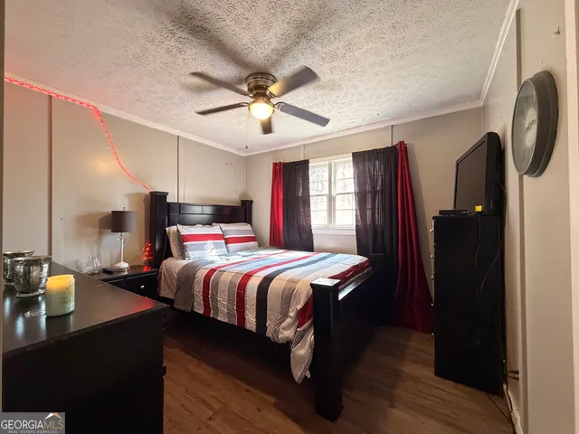 a bedroom with double bed and a chandelier