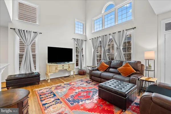 a living room with furniture a rug and a flat screen tv
