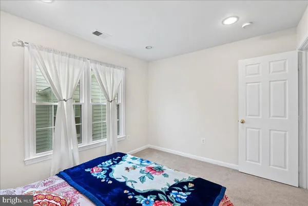 a bedroom with bed and a window