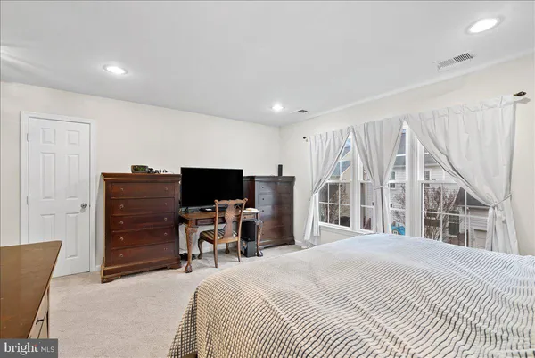 a bedroom with a bed and a flat tv screen