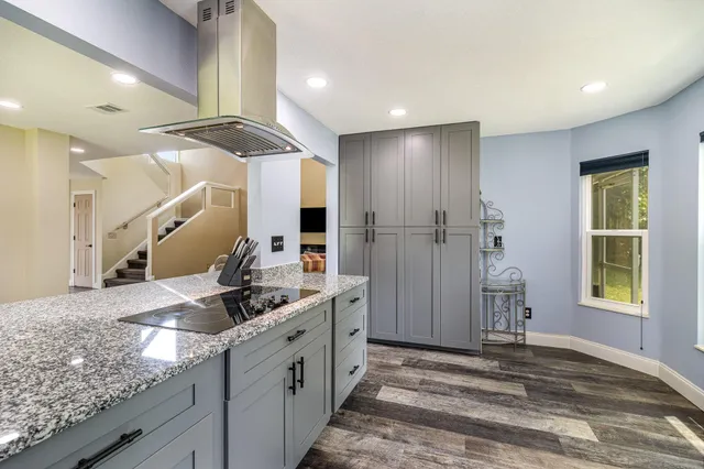 a bathroom with a granite countertop sink mirror and shower
