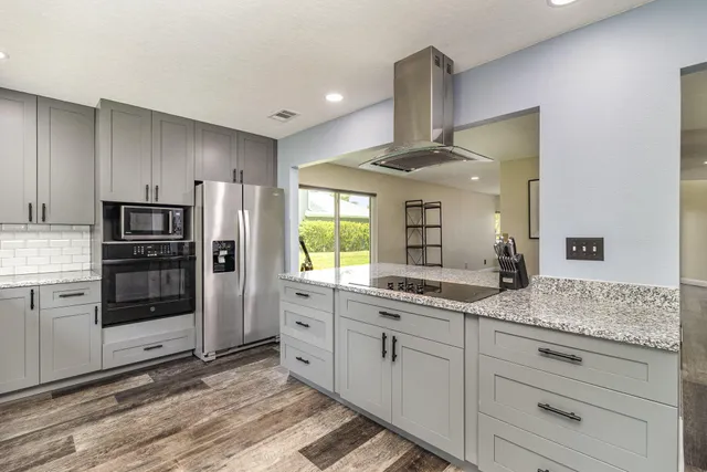 a kitchen with stainless steel appliances a refrigerator sink and cabinets