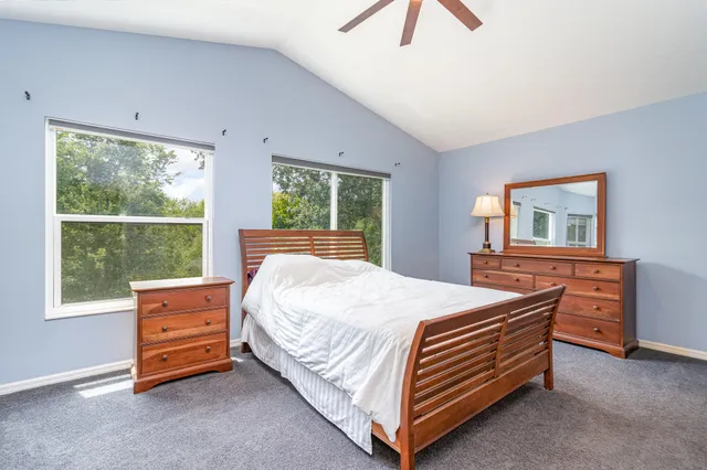 a bed sitting in a bedroom next to a window
