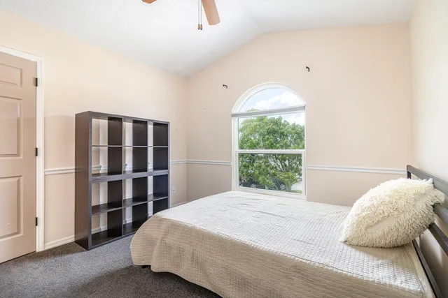 a bedroom with a bed and a window