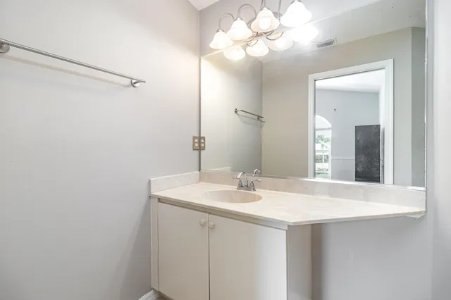 a bathroom with a sink vanity and a mirror