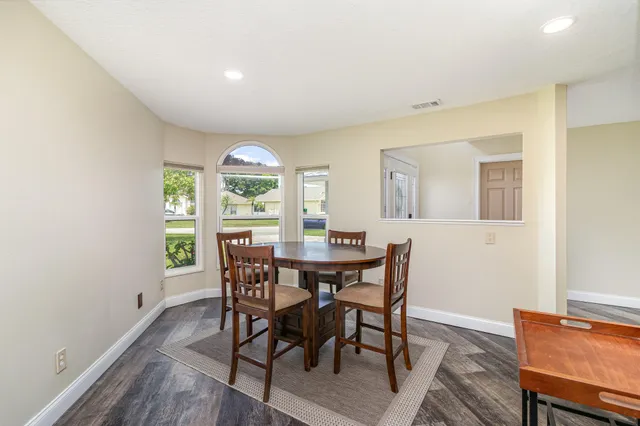 a view of a dining room with furniture window and wooden floor