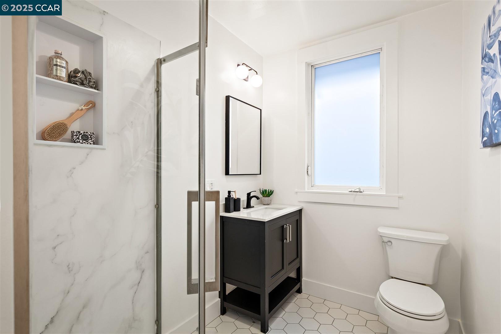 1233 Haskell Street Berkeley, CA 94702 - Photo 12 of 24 a bathroom with a sink a toilet and mirror