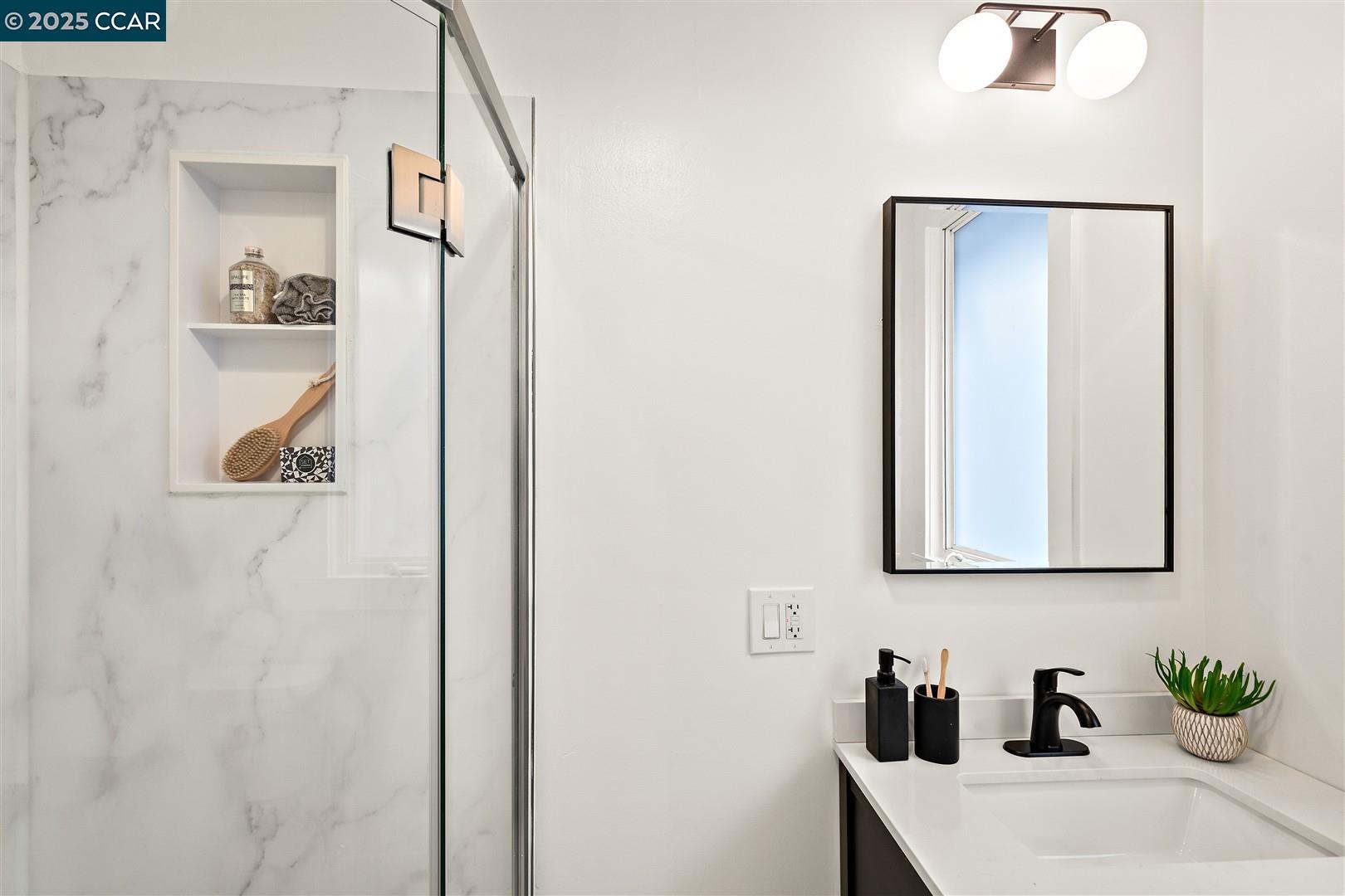 1233 Haskell Street Berkeley, CA 94702 - Photo 13 of 24 a bathroom with a sink and a mirror
