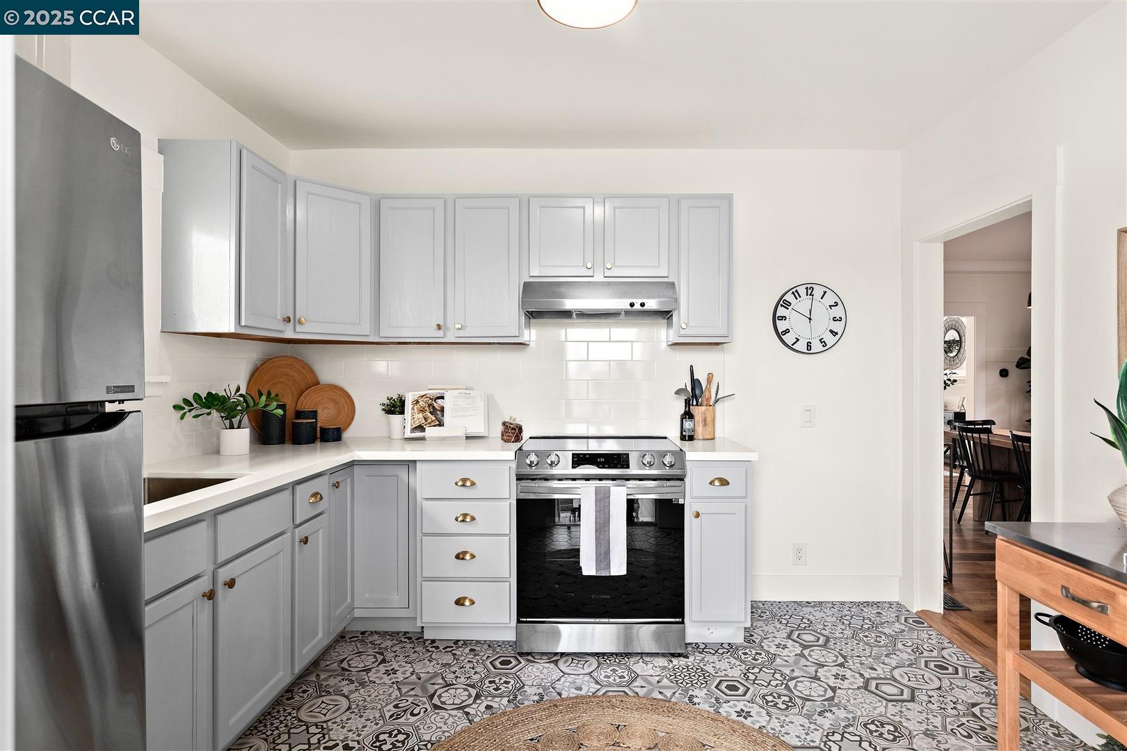 1233 Haskell Street Berkeley, CA 94702 - Photo 15 of 24 a kitchen with stainless steel appliances granite countertop a stove a sink and a refrigerator