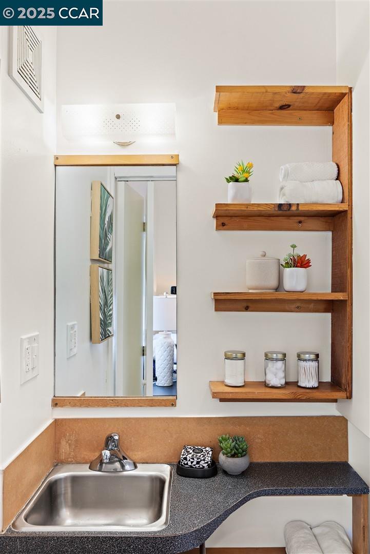 1233 Haskell Street Berkeley, CA 94702 - Photo 22 of 24 a bathroom with a sink and a mirror
