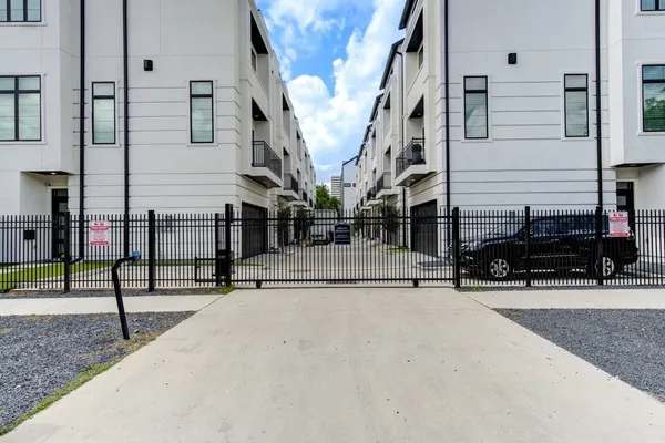 a view of a street with parked cars
