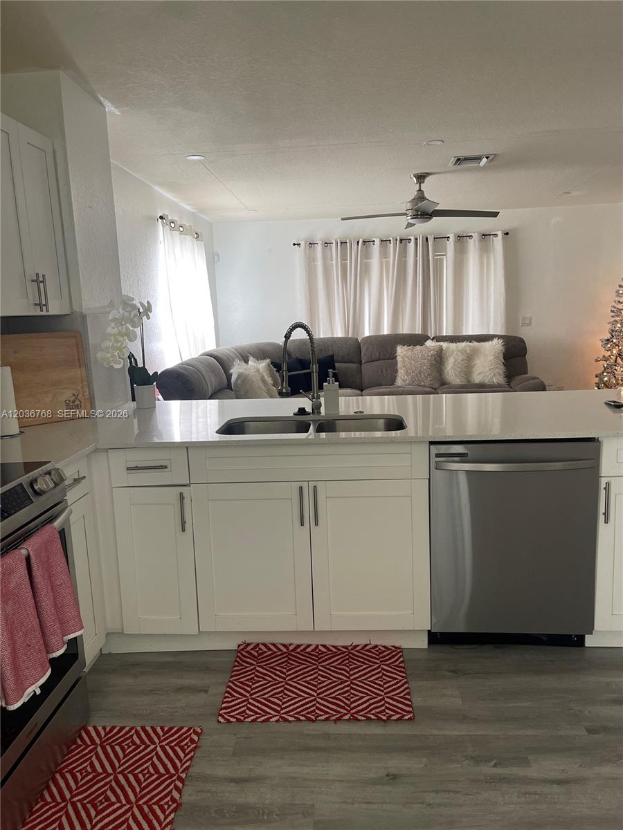 2432 Southwest 99th Way Miramar, FL 33025 - Photo 3 of 17 a kitchen with a sink cabinets and wooden floor