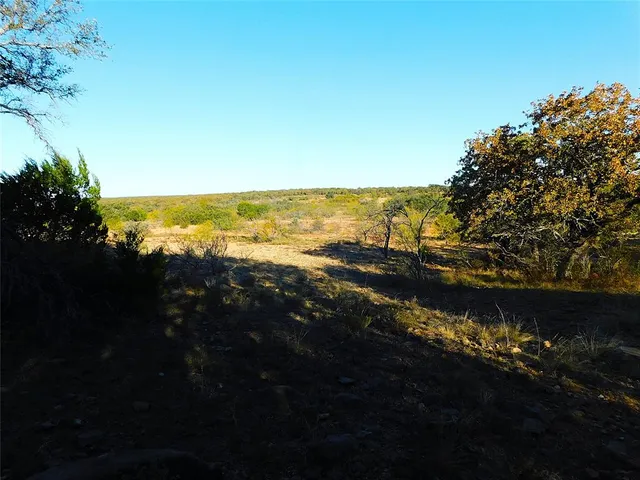 a view of a beach with a mountain in the background