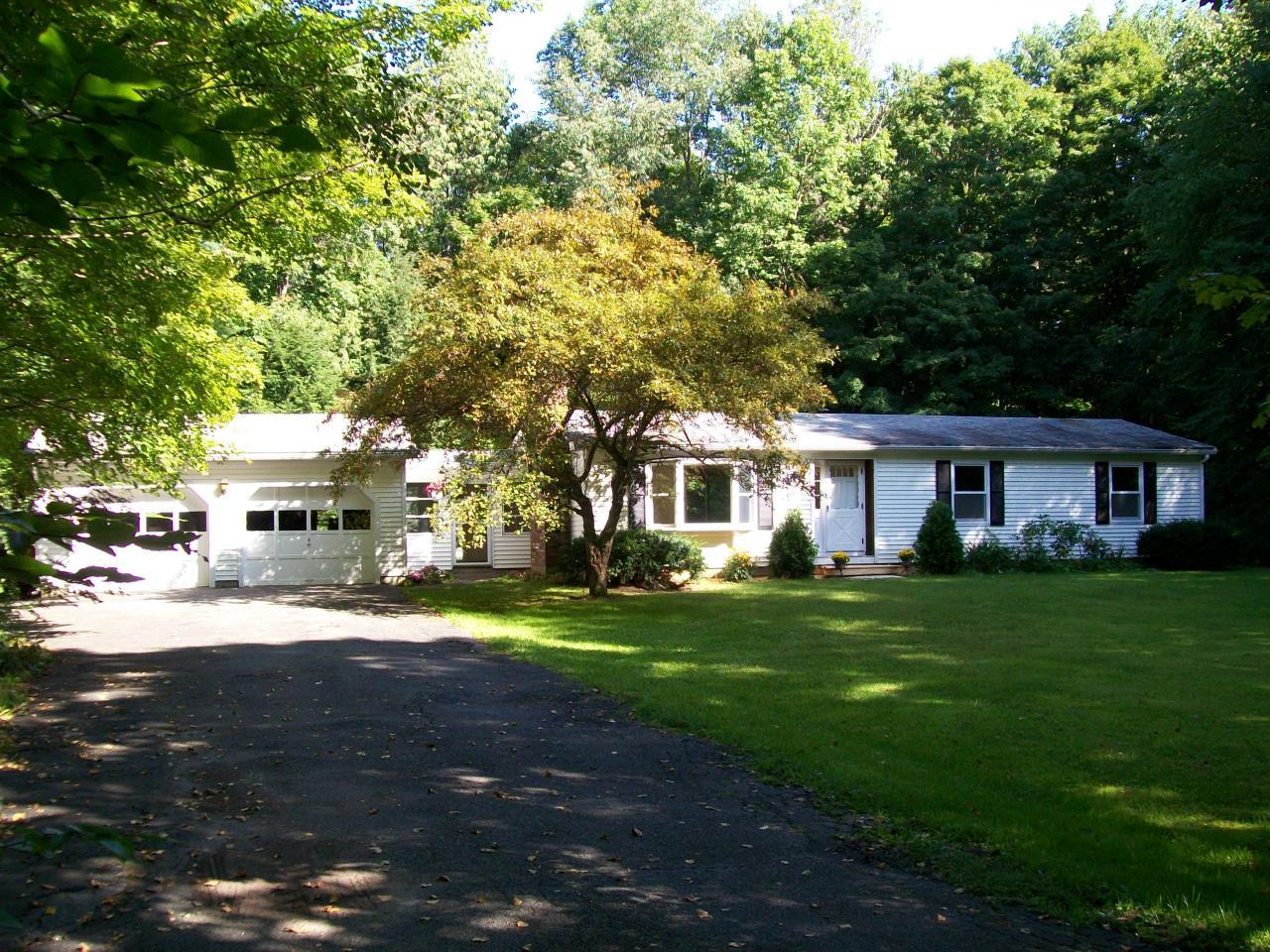 2017 Swamp Road Richmond, MA 01254 - Photo 1 of 16 a front view of a house with a garden