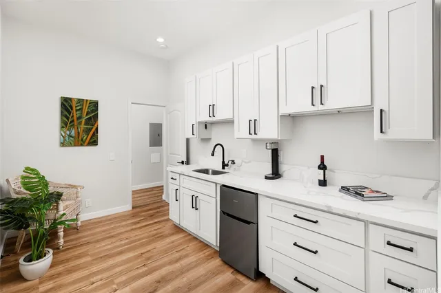 a kitchen with stainless steel appliances granite countertop a sink a stove and cabinets