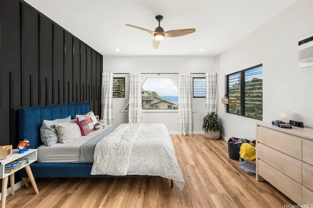 a bedroom with a bed and wooden floor