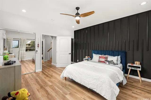 a bedroom with bed and wooden floor