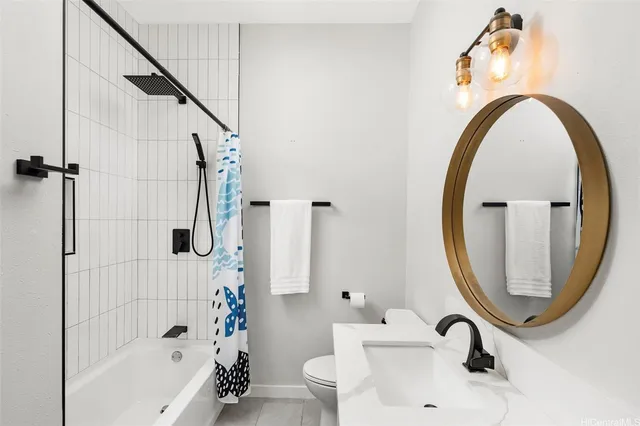 a bathroom with a sink a toilet and a mirror