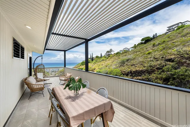 a balcony with table and chairs
