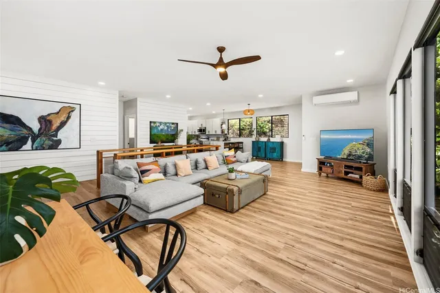 a living room with furniture and a wooden floor