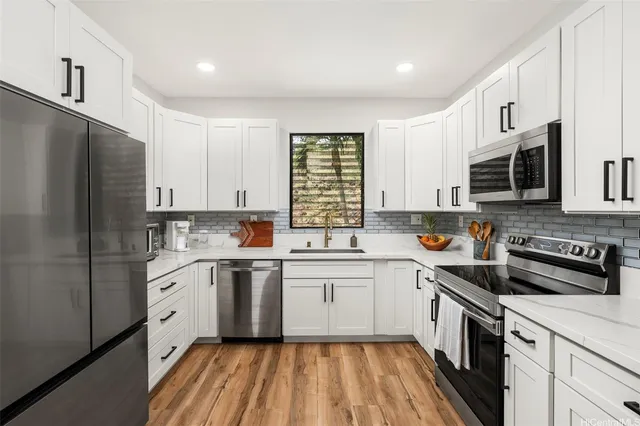 a kitchen with a white cabinets and white appliances