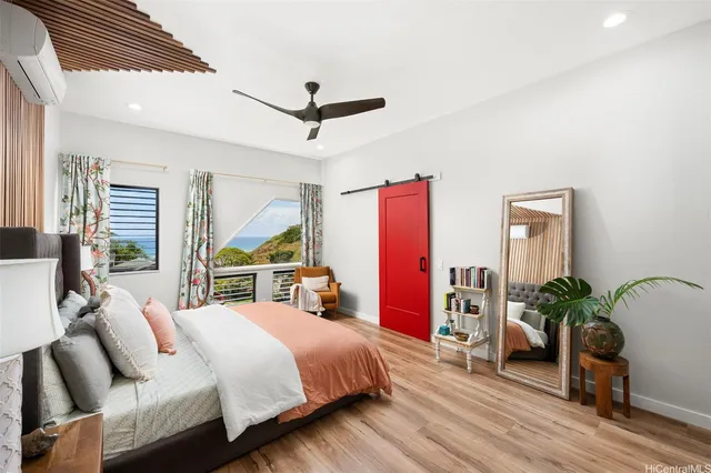 a bed room with a bed and a potted plant