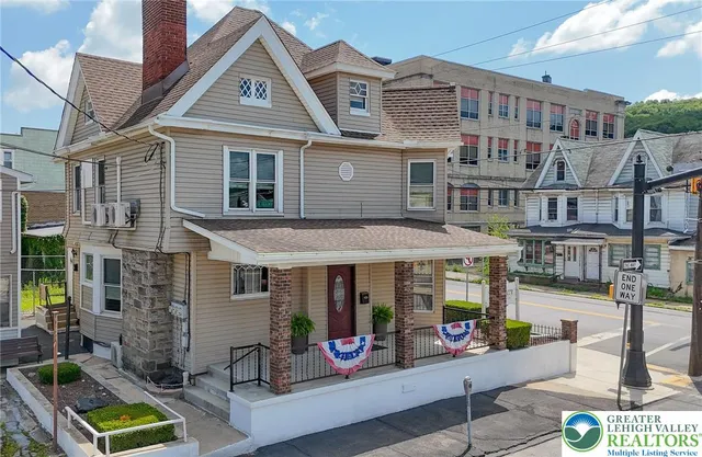 a front view of multi story residential apartment building with retail shops