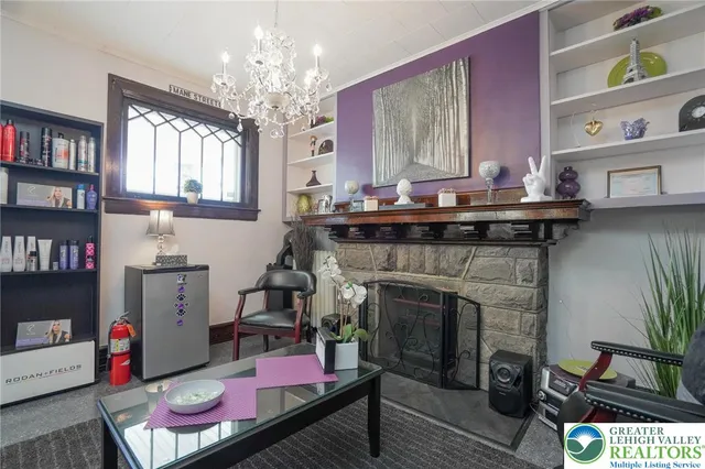 a living room with furniture a chandelier and a dining table