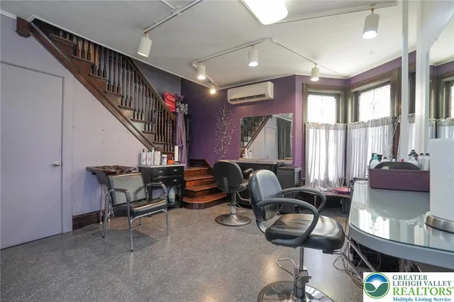 a view of a kitchen with white cabinets and wooden floor