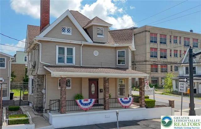 a front view of a building with sitting area