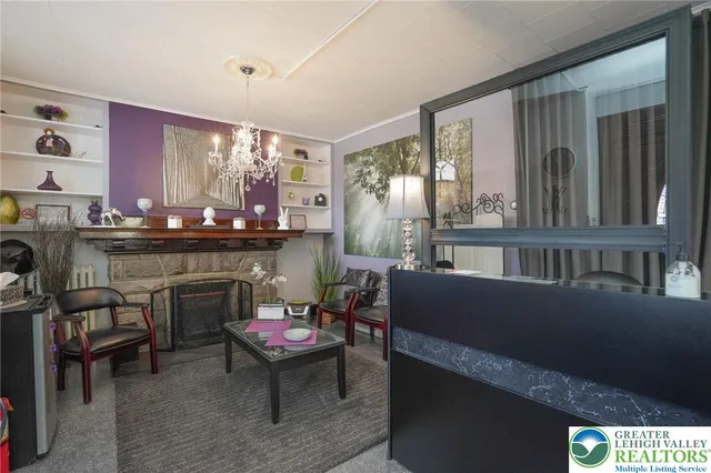 a living room with furniture and a fireplace